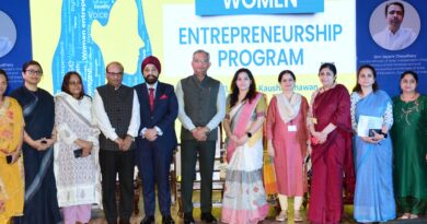 a group of people standing in front of a sign Women Entrepreneurship