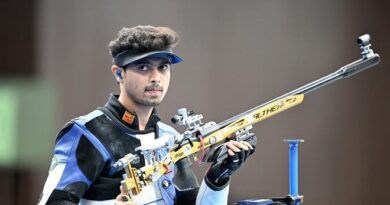 Swapnil Kusale holding a gun at Paris Olympics 2024